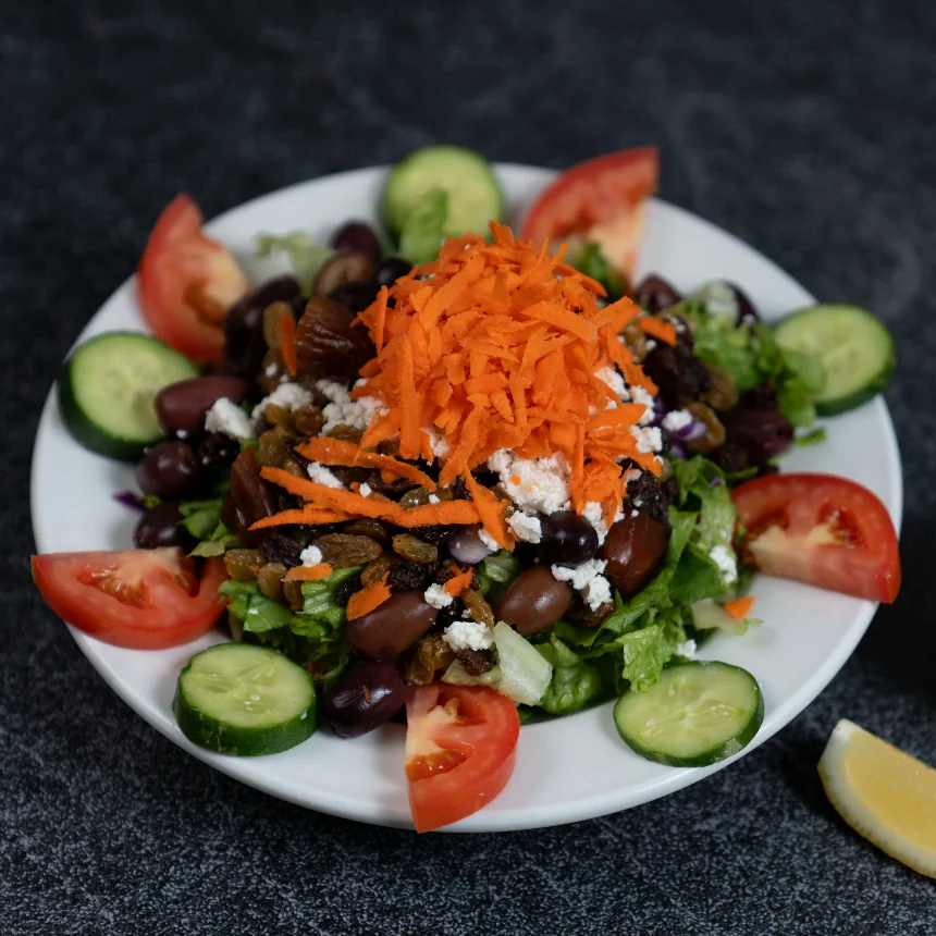 Darband Salad, Feta cheese, kalamata olives, cucumber, red cabbage, green pepper, tomato on a bed of romaine lettuce with our house dressing (olive oil and vinegar). With walnuts, raisins and dates.